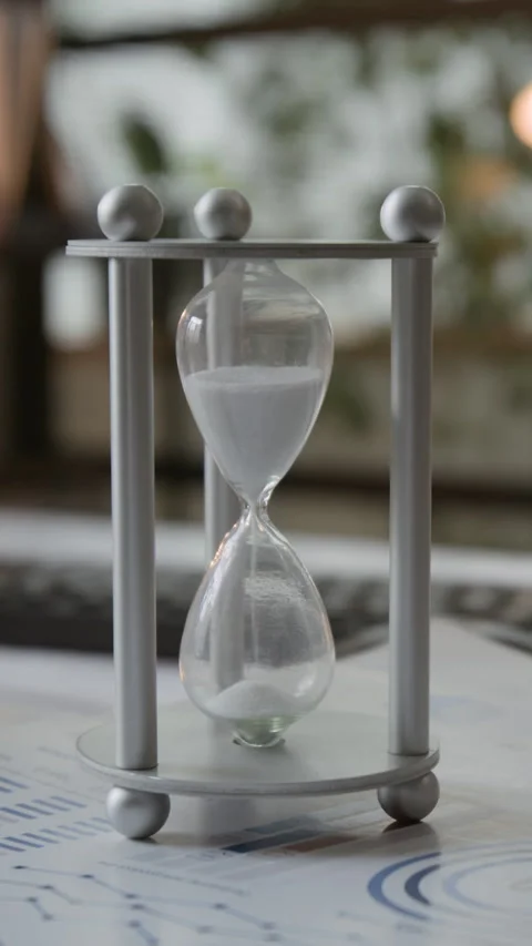 Silver Hourglass On Graph Paper Stack Stock Footage 330481598