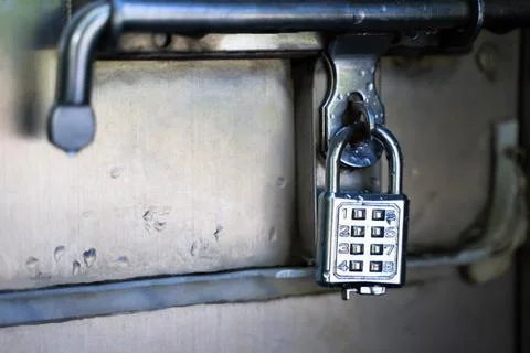 Silver key with code for safe storage Stock Photos