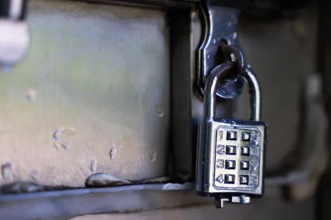 Silver key with code for safe storage Foto stock