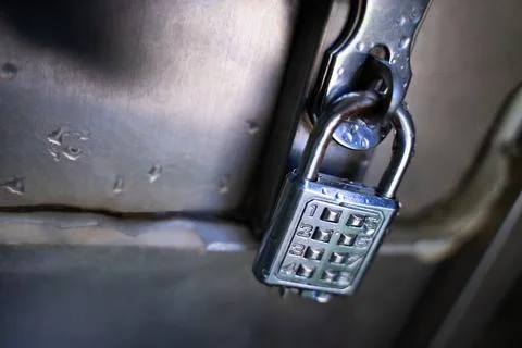 Silver key with code for safe storage Stock Photos