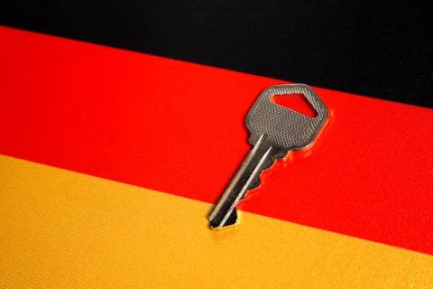 Silver key on the flag of Germany. Close-up, copy space Stock Photos