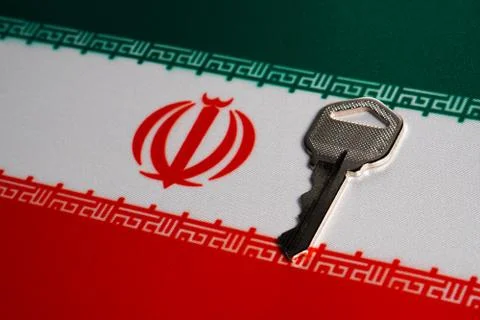 Silver key on the flag of Iran. Close-up, copy space Foto stock