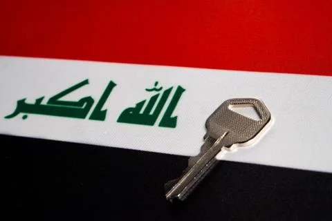 Silver key on the flag of Iraq. Close-up, copy space Stock Photos