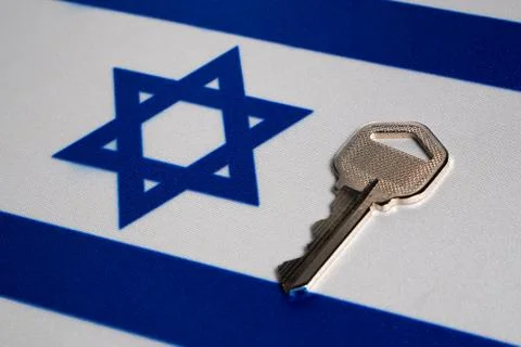 Silver key on the flag of Israel. Close-up, copy space Stock-Fotos