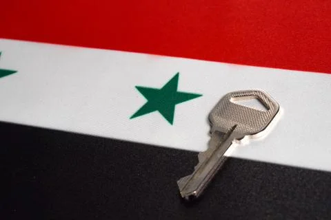 Silver key on the flag of Syria. Close-up, copy space Stock Photos
