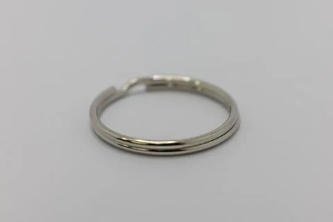 A silver keychain ring is shown on a white background. Stock Photos