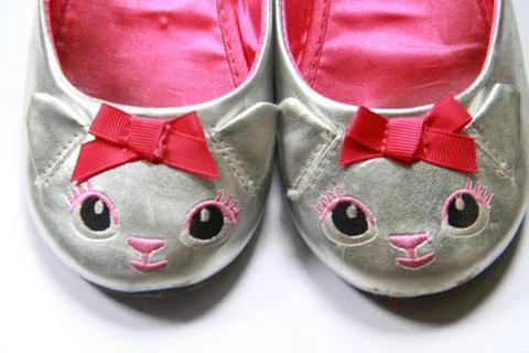 Silver kitten ballet shoes evoke memories of a girly childhood Stock Photos