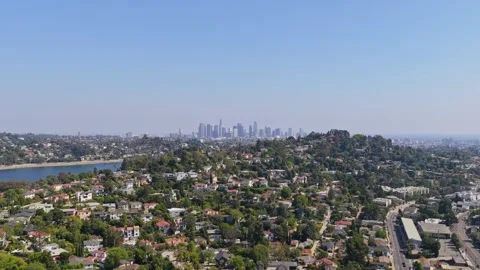 Silver Lake Reservoir and Echo Park neighborhood with Los Angeles downtown skyli Stock Footage 336635103