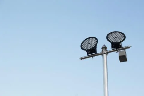 Silver lamp post with a light LED bulb on the right side and background sky. Stock Photos
