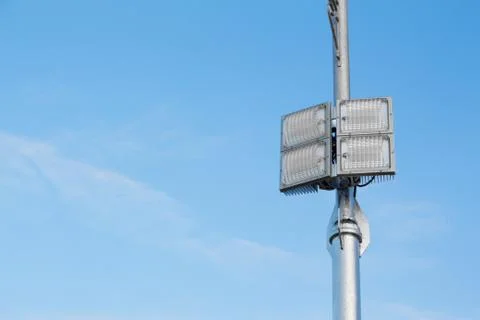 Silver lamp post with a light LED bulb on the right side and background sky. Stock Photos