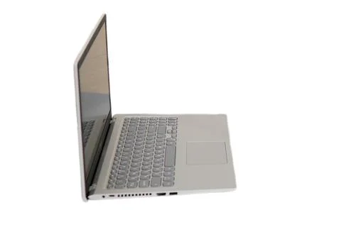Silver laptop computer shown from side view isolated on white background. M.. Stock Photos