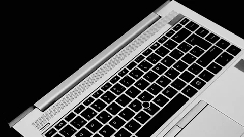 Silver laptop spinning with black background Stock Footage 201463946