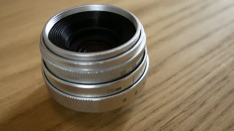 Silver lens for the camera 25mm on the table 스톡 동영상 130222895