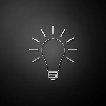 Silver Light bulb with rays shine icon isolated on black background. Energy and Illustrazione stock