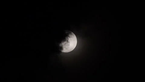 The silver light of the moon is swallowed by gathering storm clouds. Stock Footage 318471781
