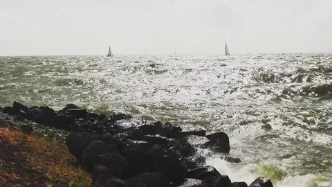 Silver lighting waves on the dike Stock Footage 95551192