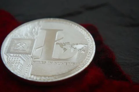 Silver litecoin on the gray stone surface Stock Photos