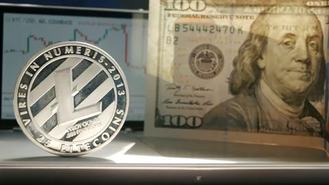 Silver Litecoin LTC fluttering on the background of a graphic stock chart Stock Footage 88715984