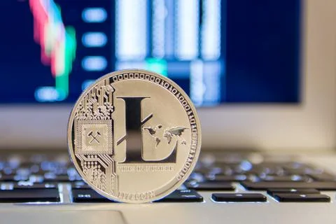 Silver Litecoin on notebook keydoard with chart Foto stock