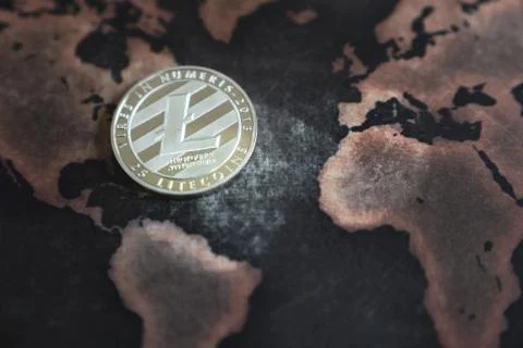 Silver Litecoin Token on World Map in Asia Stock Photos