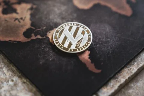 Silver Litecoin Token on World Map in Asia Stock Photos
