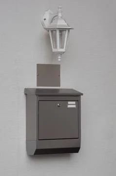 A silver mailbox on the wall Foto stock