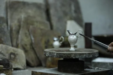 Silver master makes coffee cups Stock Photos