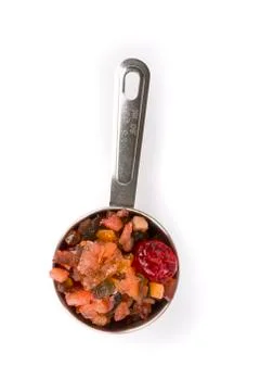Silver measuring cup containing fruit cake mix top down view Stock Photos