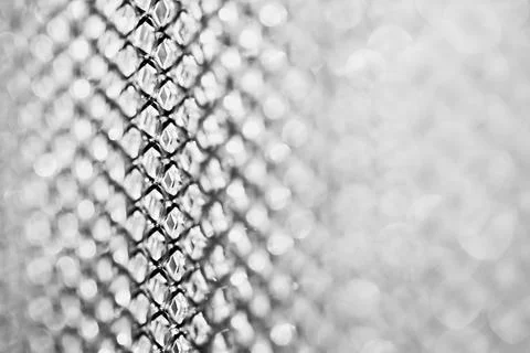 Silver mesh fading into soft white bokeh with shallow focus and bright airy.. Foto stock