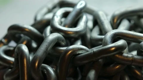 Silver metal chain rotates in a circle Stock Footage 228718465
