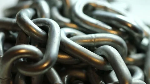 Silver metal chain rotates in a circle Stock Footage 228718467