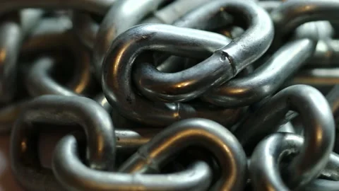 Silver metal chain rotates in a circle Stock Footage 228718481