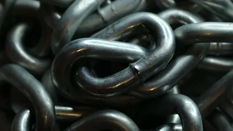Silver metal chain rotates in a circle Stock Footage 228718496