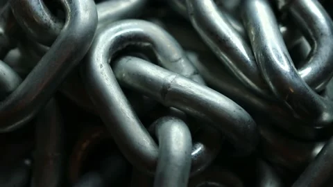 Silver metal chain rotates in a circle Stock Footage 228718504