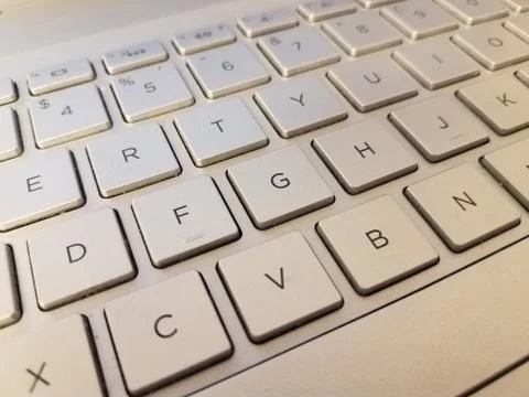 Silver metal keyboad on computer with letters Stock Photos