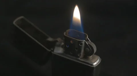 Silver metal lighter on black background with flame. Stock-Footage 43238450