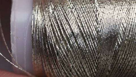 Silver metallic thread for gold sewing and embroidery. Factory winding on a plas Stock Footage 129148551