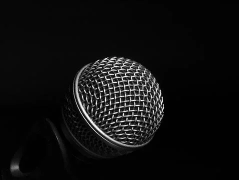 Silver microphone on a black background. Stock Photos