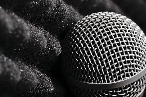 Silver microphone on a black background. Stock Photos