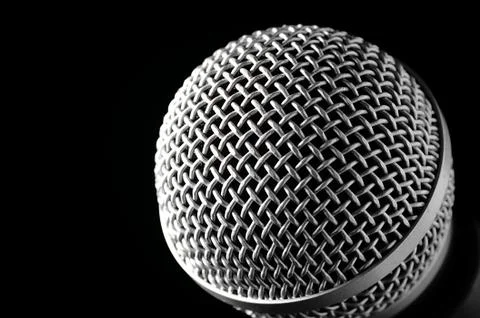 Silver microphone on a black background. Stock Photos