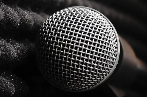 Silver microphone on a black background. Stock Photos