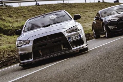 Silver mitsubishi lancer evolution parked on road Stock Photos
