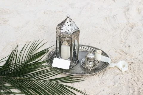 Silver Moroccan lantern with cup of tea, coffee and date palm leaf . Vintage Stockfoto's