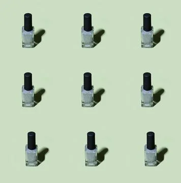 Silver nail polish pattern on basil green background Stock Photos