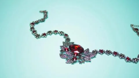 Silver necklace with ruby on a blue background. fashion design Stock Photos