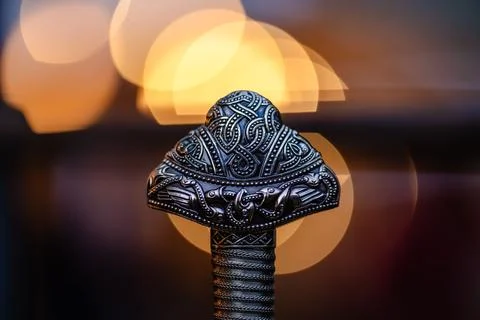 A silver object with a design on it Stock Photos
