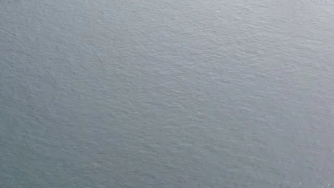 Silver ocean surface with fine ripples, subtle movement texture background Video stock 332553590