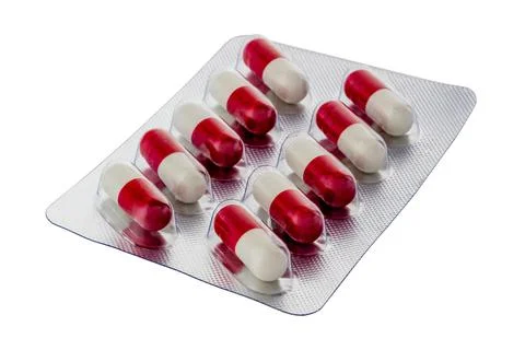 Silver packaging of two-color tablets isolated on white background Stock Photos