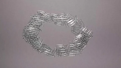 Silver paper clips on gray background with copy space Stock Footage 123808760