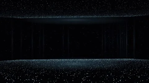 Silver particles drift and swirl in a dark cavern illuminated by faint vertical 库存影片 345185246